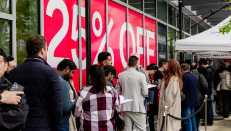 Buyers queued up in front of red flash condo sale sign